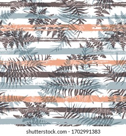 Stylish new zealand fern frond and bracken grass over painted stripes seamless pattern design. South african forest foliage beach fashion fabric print. Tropical leaves and stripes seamless.