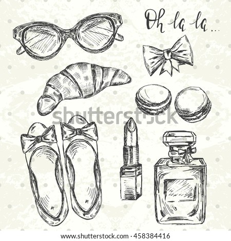 Stylish Paris set. Hand drawn shoes, glasses, lipstick, bow, macrons, croissant, perfume and text "oh la la" 