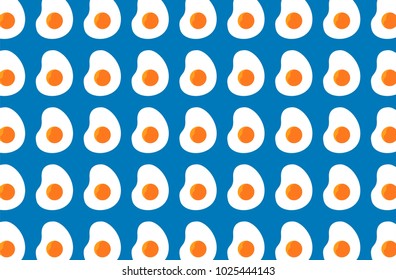 Stylish seamless pattern featuring playful fried egg illustrations over a bright blue backdrop. Perfect for adding a fun and cheerful vibe to design projects, presentations, or crafting purposes.