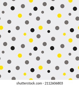 Stylish seamless pattern with polka dots. Gray and yellow circles chaotically on a light background. Vector template.