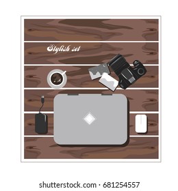 
Stylish set of photographer: laptop, hard drive, camera, photos and coffee on a wooden background. Flat style.