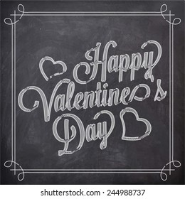 Stylish text Happy Valentines Day written by white chalk with hearts shape on blackboard background.