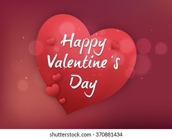 Stylish text Happy Valentine's Day on red glossy elegant heart.