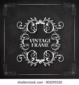 Stylish vintage frame with beautiful floral design created by white chalk on blackboard background.