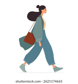 Stylish woman walking with a bag in casual attire on a sunny day in an urban setting