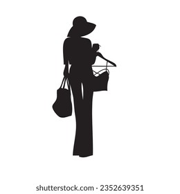 Stylish woman with a wooden hanger in her hand
