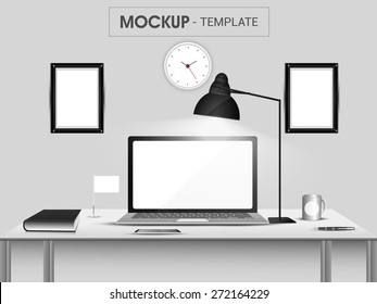 Stylish workspace with laptop, smartphone, book, coffee mug, frame and clock on grey background.