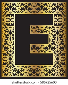 Stylized black letter E with gold ornament. Paper cut, wood cut.