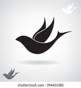 Stylized black silhouette of a flying bird. 