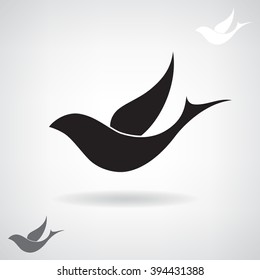 Stylized black silhouette of a flying bird. 