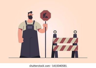 Stylized Character. Worker Holding "Road Works" Sign. Retro Style. Vector Illustration - Powered by Shutterstock - Get 15% off with code: PIKWIZARD15