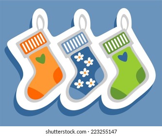 Stylized Christmas stockings set on a blue background.