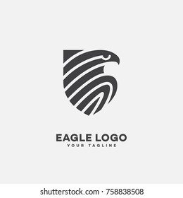 Stylized eagle logo template design with a shield. Vector illustration.