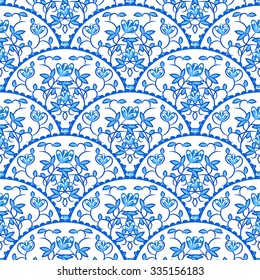 Stylized fish scale japan wave seamless pattern. Flower branches swirls in blue porcelain colors. Fan or peacock tail ornament.