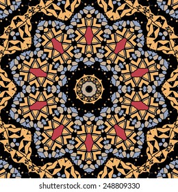 Stylized flower. Mandala like design of yellow color. Seamless tribal pattern.