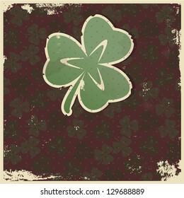 Stylized paper clover leaf on a grunge background
