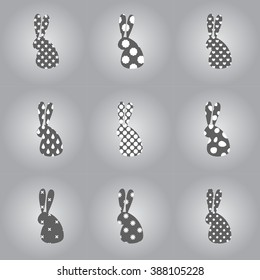 Stylized rabbit silhouettes on grey background. Modern Easter icons. Vector image