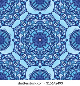 Stylized winter background with mandalas. Vector seamless oriental ornament in blue tones. Bright ornate pattern for any surface.