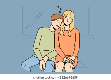 Subway passenger sleeps on shoulder of woman embarrassed by tactlessness of unfamiliar guy invading personal space. Man and girl, tired at work, ride in subway car or ground electric train