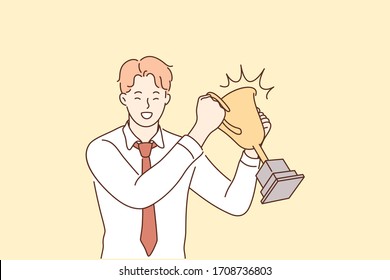 Success, celebration, win, goal achievement, business concept. Happy smiling businessman clerk leader stands with cup, celebrating victory. Business success and winning competition of young manager.