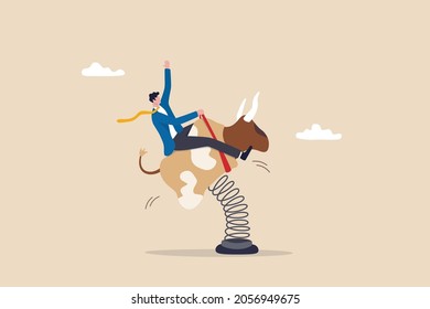 Success investor riding bull market, control risk and balance to success in stock market, challenge or uncertainty concept, confidence businessman investor riding and balance himself on rodeo bull.