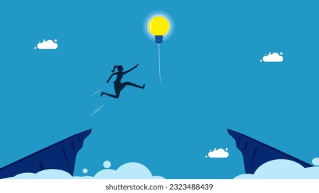 Success in learning new things. woman jumping and grabbing a light bulb balloon