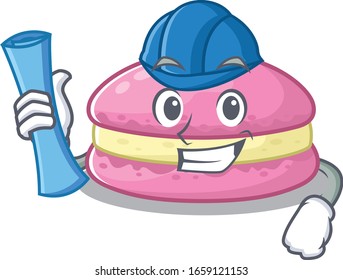 A success of strawberry macarons Architect having blue prints and blue helmet