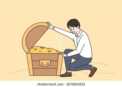 Success wealth and riches concept. Young smiling man sitting and looking at chest full of golden coins hidden treasures money vector illustration 