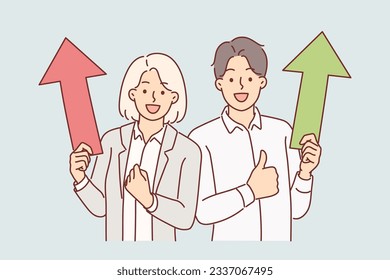 Successful business man and woman holding up arrows showing victory gesture rejoicing in career achievements. Concept of successful completion of project and growth of capital or dividends