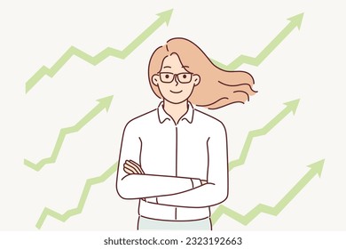 Successful businesswoman stands with arms crossed near arrow-graphs pointing up. Successful woman manager is proud of business achievements and increasing company profits due to ambitious lifestyle