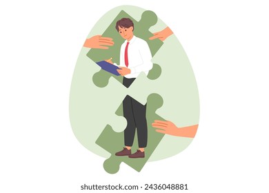 Successful man manager assembled from puzzle pieces stands with pencil and clipbord in hands. Guy manager of large corporation writes down names of employees who deserve bonus payment or punishment