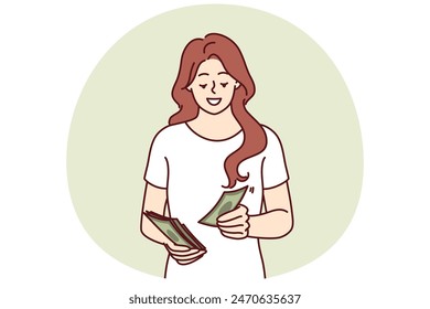 Successful woman counts money earned in business or received from dividend investments with good profit. Smiling girl with cash saves money wanting to make pension contribution or pay taxes