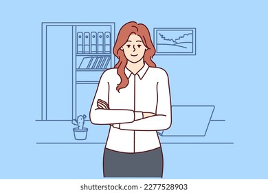 Successful woman office worker stands with arms crossed near desktop and looks at screen. Businesswoman works as accountant or provides auditing services for entrepreneurs and successful business 