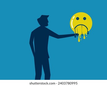 Suffering disappears. man holds a melting sad face icon