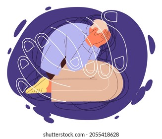 Suffering person sits on his knees with his hands over his face and feels depressed