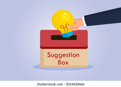 Suggestion vector concept. Hand putting a light bulb into a suggestion box