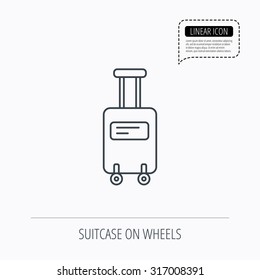 Suitcase with wheels icon. Travel baggage sign. Linear outline icon. Speech bubble of dotted line. Vector