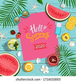 summer background with fruits, palm leaves and cocktail on wooden boards top view