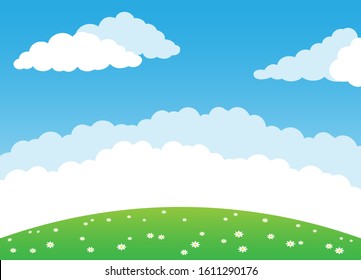 Summer background with green meadow and clouds in the blue sky.