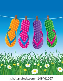 summer background with hanged beach flips and green grass, flowers