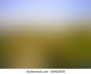 Summer background with landscape of green grass, yellow road and blue sky, blurred texture, in vector