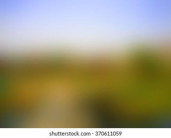 Summer background with landscape of green grass, orange road and blue sky, blurred texture, in vector