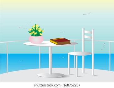 Summer. Balcony with sea view and a table with a book.