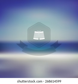 Summer beach background turquoise sea and blue sky with vintage hue. Sandy poster or card. Symbol of man swimsuit on hexagonal badge and ribbon. Eps10 vector illustration.