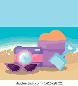 summer beach scene with camera and sand bucket