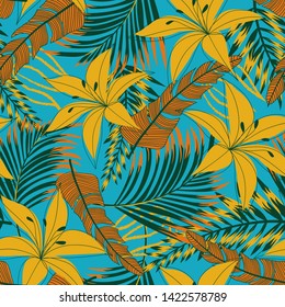 Summer bright seamless pattern with tropical leaves and flowers on blue background. Vector design. Jung print. Floral background. Printing and textiles.