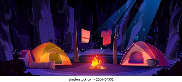 Summer camp in night forest cartoon illustration. Vector design of two tents illuminated by bonfire flame in moonlit midnight wood, clothes drying over fire. Tourism and travel adventure at weekend