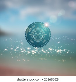 Summer design with blurred marine background. Typography retro label with compass.