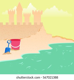 Summer fun sand castle at the beach with toy bucket shovel.