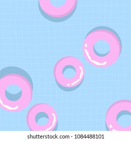 Summer holidays concept. Pink life rings floating in the swimming pool 